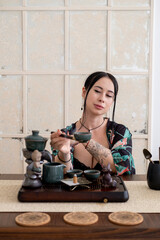 Chinese traditional drink. Tea ritual. Female hand preparing ceremony enjoying meditation aromatherapy vapor spiritual enlightenment.