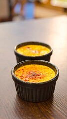 Two ramekins of warm custard