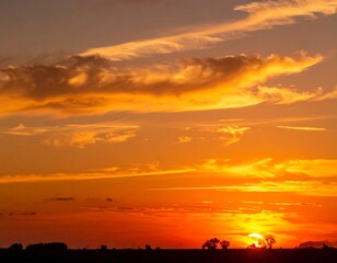 Fototapeta premium Beautiful sunset with orange, red, and yellow hues over a landscape