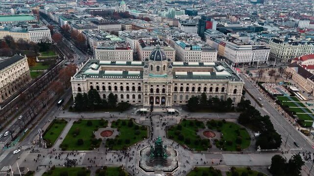 Static aerial drone shot of the Vienna Natural History Museum in Austria, showing its grand fa&ccedil;ade and surrounding city streets, with buildings and rooftops illuminated by clear winter sunlight.