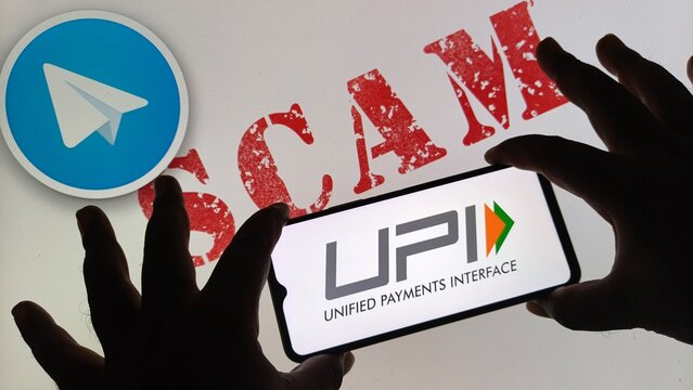 Hands holding smartphone displaying upi payment interface with telegram logo and red scam text in background