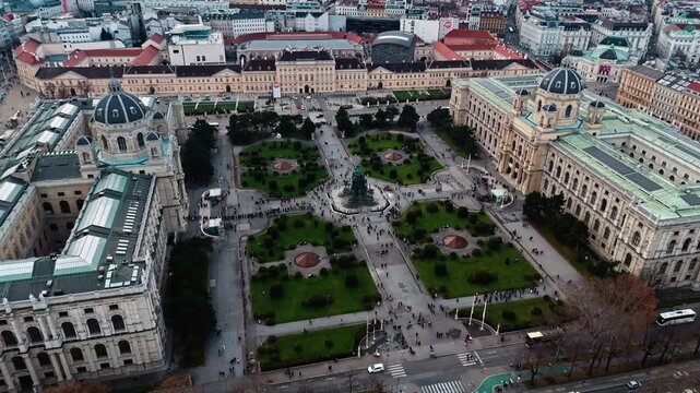 Aerial drone shot panning left over Vienna&rsquo;s twin museums, Kunsthistorisches and Natural History, facing Maria-Theresien-Platz, with winter sunlight illuminating fa&ccedil;ades and the surrounding city