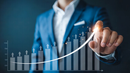 Businessman analyzing growing graph with upward trend