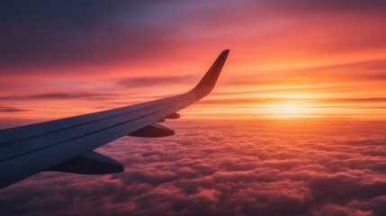 A stunning sunset view from an airplane wing, showcasing vibrant colors illuminating the clouds below.