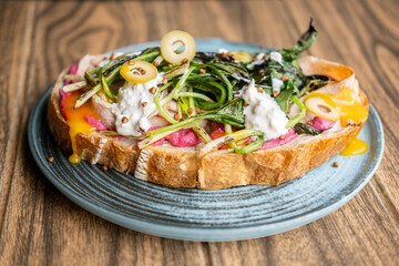 Breakfast served. Delicious bruschetta. Healthy veggie toast with beetroot herbs food. Runny creamy sauce with grilled greens on bread.