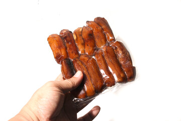 Tradisional Food From Dried smoke Bananas, in plastic packaging, isolated on white background, good for article or commercial