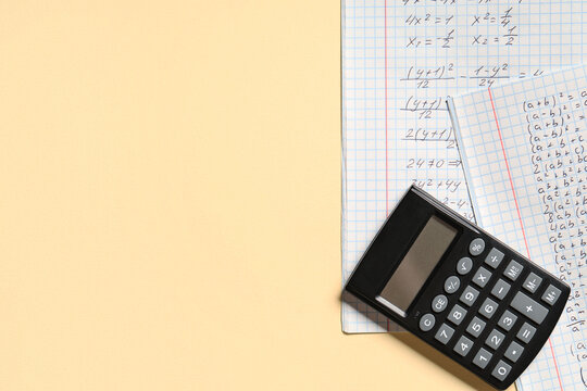 Copybook with handwritten maths formulas and calculator on yellow background - Powered by Adobe