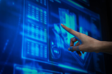 Futuristic woman interacting with virtual holographic interface, touching transparent digital screens in blue cyber environment, data controly, immersive human computer interaction.