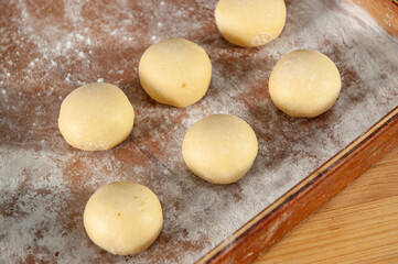 Professional baker shaping fresh dough by hand for traditional artisan bread