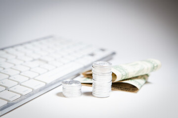 laptop and coins on white background