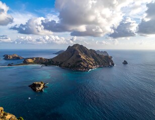 Fototapeta premium Aerial view of a remote island surrounded by tranquil ocean waters and clouds