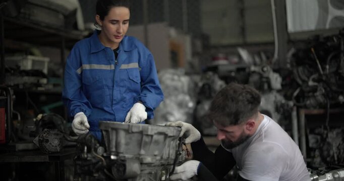 Auto mechanic disassemble mechanical engine components for diagnosis, troubleshooting in automotive workshop. Technical expertise, precision required in field of vehicle repair and maintenance.
