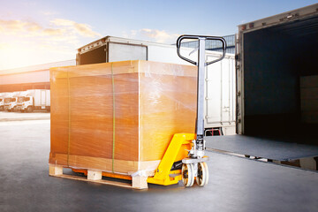 Bulk of Package Boxes Waiting to be Loaded into Containers Trucks. Forklift Pallet Jack. Distribution Warehouse, Shipping Cargo Container. Freight Truck Logistics Transportation.	