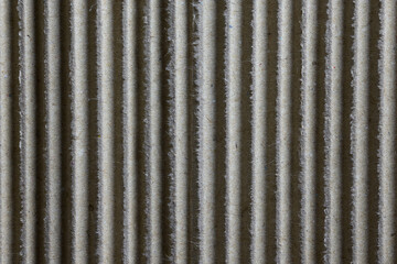 Macro texture of brown corrugated cardboard, vertical lines