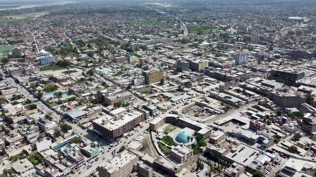 Drone aerial view of Jalalabad City reveals a landscape defined by its dense urban fabric and captivating architecture and turquoise mosque
