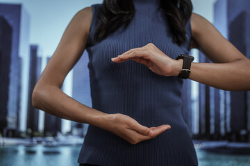 Businesswoman hand toward a modern city skyline, smart urban development, investment opportunity, corporate vision, real estate growth, future planning, innovative metropolitan business.