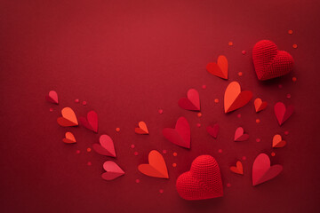 Saint Valentine Day hearts decoration on red background top view. Festive composition for love greeting and amour holiday.