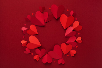 Valentine day round frame background with red hearts top view. Festive mockup or template for february love holiday design and promotion.