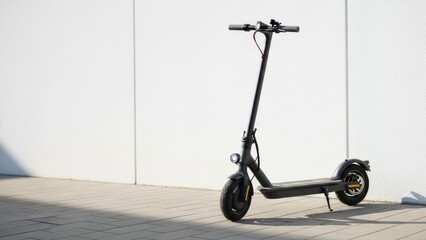 Electric scooter parked on paved surface beside white wall. Urban mobility, eco transport.