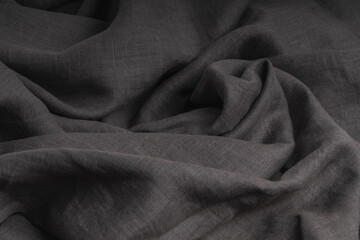 Minimalist gray background made of soft linen fabric with beautiful folds.