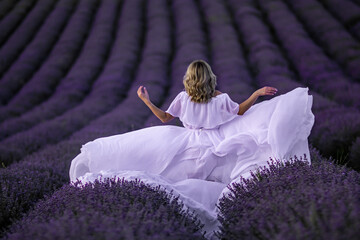 Lavender Fields Provence Woman WhiteDress: Summer photoshoot showcasing a woman in a white dress amidst purple lavender fields in Provence, France.