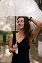 Woman, umbrella, rain, serene woman enjoying refreshing rain with clear umbrella in park with copy space