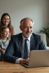 Businessman working on laptop with family