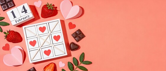 Valentine Day Flat Lay with Calendar February Fourteenth, Hearts and Chocolate on Coral Background with Copy Space, Romantic Holiday Composition