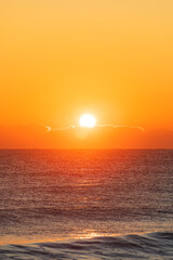 Sunrise Light Behind Low Clouds Over the Ocean