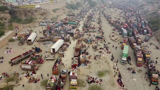 Trucks loaded with people arriving in Torkham Refugee camp in mountains for Afghans who have come from Pakistan, Aerial drone, Afghanistan