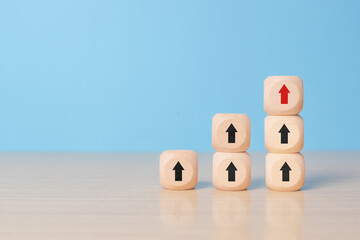 Wooden blocks stacking as step stair with red arrow up, blue background, Business growth success process concept, copy space