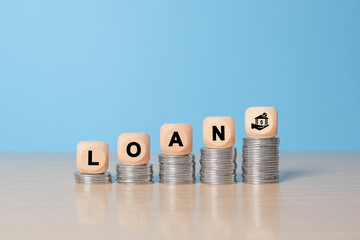 loan text on wood cube block stack with coins