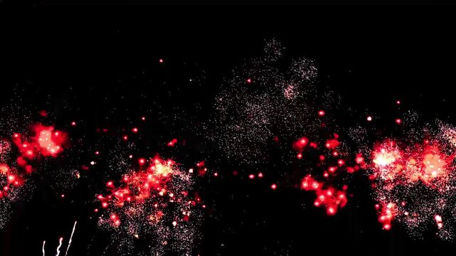 4K Brilliant fireworks explode against a deep black night sky, creating sparkling red and gold bursts. Festive celebration background ideal for holidays, festivals, New Year events, and dramatic ni