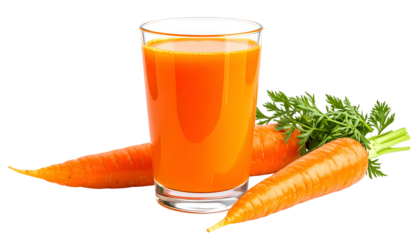 A glass of vibrant orange juice next to fresh carrots and green leafy tops