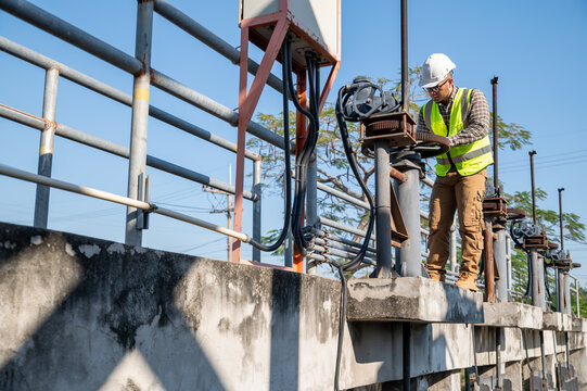 Field Engineer Checking Mechanical Systems at Dam and Water Management Facility