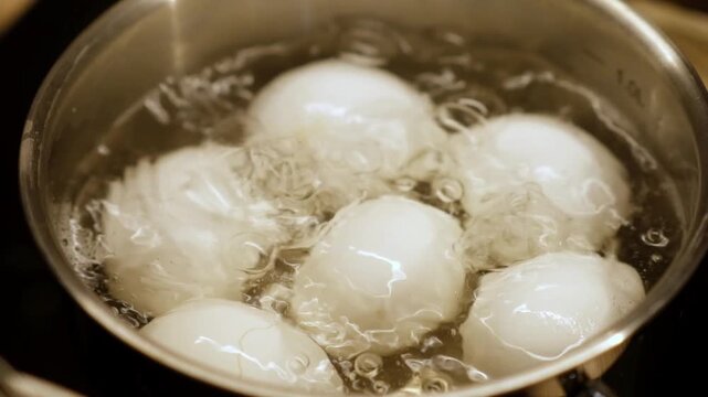 A guide to boiling eggs on the stovetop, showcasing the water bubbling as six eggs cook for a nutritious meal, perfect for breakfast or snacks.