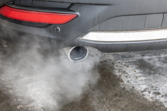Car exhaust pipe with car idling in Winter