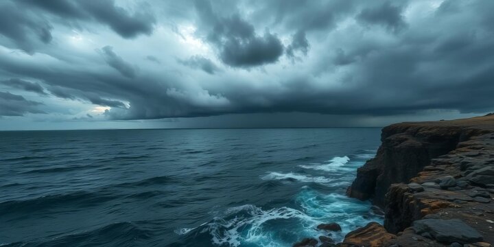 Dark stormy sea with ominous clouds, rocky cliff edge, ocean,  waves