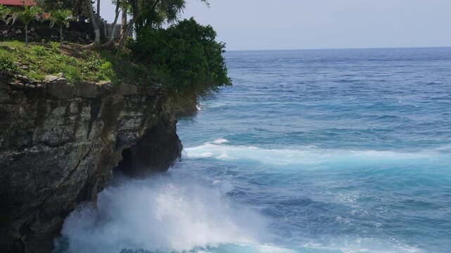 Powerful waves crashing against coastal rocks demonstrate ongoing erosion and natural transformation Waves sculpt shoreline with force revealing how waves constantly reshape nature and time
