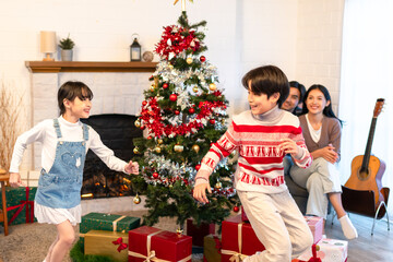Asian loving family celebrating Christmas party together in house.