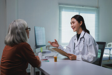 Doctor discussing health with senior female patient