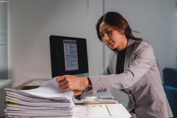Young businesswoman organizing documents and managing paperwork