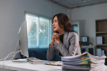 Young businesswoman experiencing stress working late at office