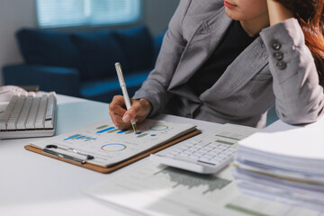 Businesswoman analyzing financial data working late at night