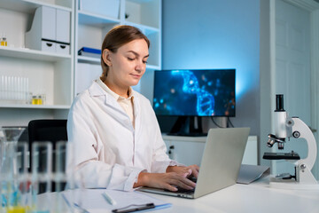 Caucasian female scientist in white lab coat working in the laboratory. 