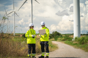 Wind energy inspection by engineers wind farm professional collaboration outdoor eye-level renewable energy
