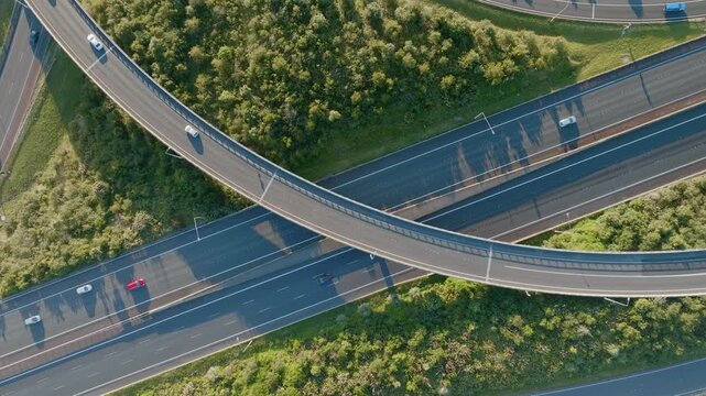 Aerial view of cars driving on a highway overpass in Manukau, Auckland, New Zealand. Vehicles are commuting during the day, showcasing transportation infrastructure.
