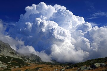 Massive cumulus clouds drifting over a landscape, showcasing atmospheric formations and natural grandeur