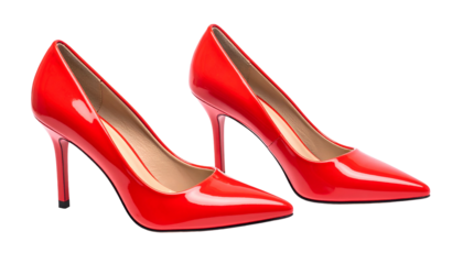 A pair of glossy red high-heeled shoes isolated against a stark black background