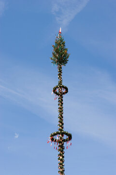 Decorated maypole outdoors in Traunkirchen Austria against blue sky